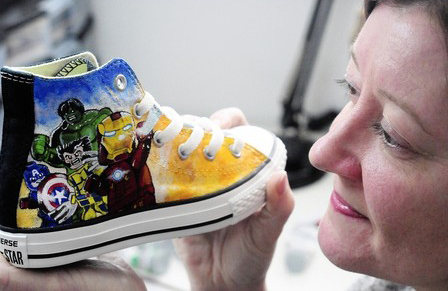Ange Lord holding Converse footwear